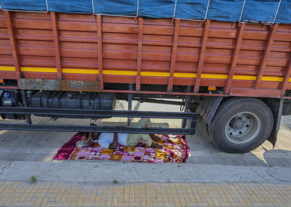 Indian truck driver takes a nap under a his parked truck on a hot summer day in Srinagar, Indian controlled Kashmir, Thursday, July 25, 2024. (AP Photo/Mukhtar Khan)