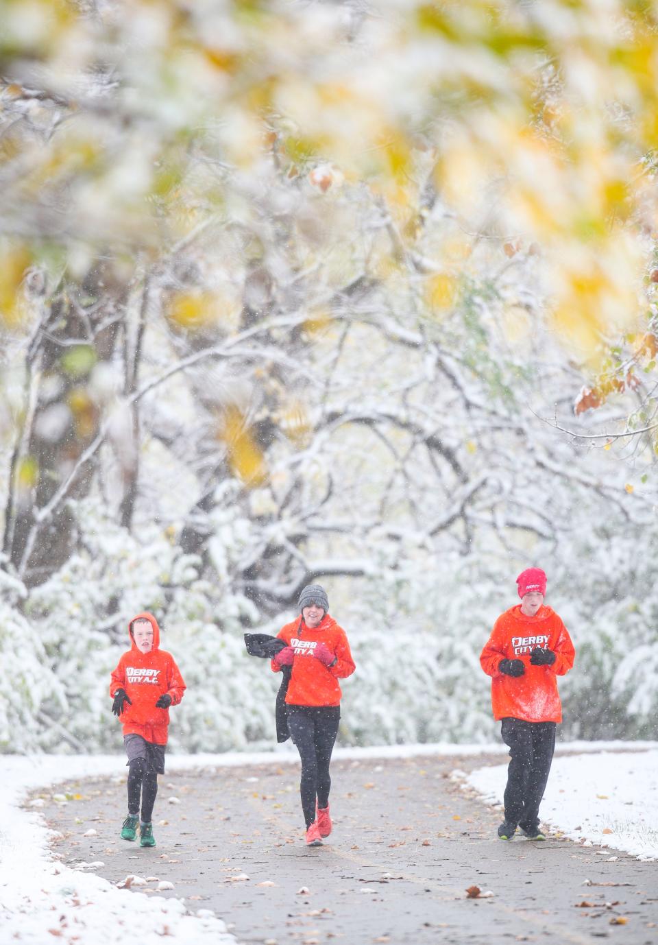 A group of runners jog up a path with a snowy Greenway landscape in Clarksville as the backdrop. Up to two inches of snow fell early Saturday morning across Southern Indiana. At times visibility was reduced due to heavy snow. It was the second snowfall of the fall season; Oct. 18 saw around an inch of snow in the higher elevations of the Louisville area. Nov. 12, 2022