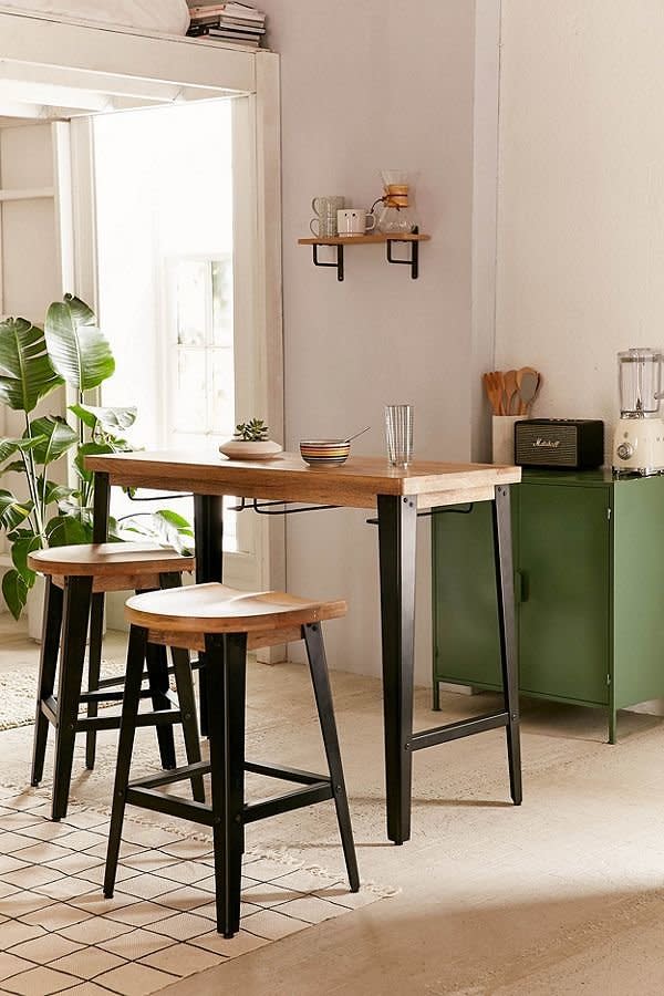 Urban's apartment section can get a bit pricey, but <a href="https://www.urbanoutfitters.com/shop/haskall-breakfast-bar?category=furniture&amp;color=001" target="_blank">this under $400 breakfast bar</a> comes with two stools and an ergonomical fit for small spaces. You can't beat that.