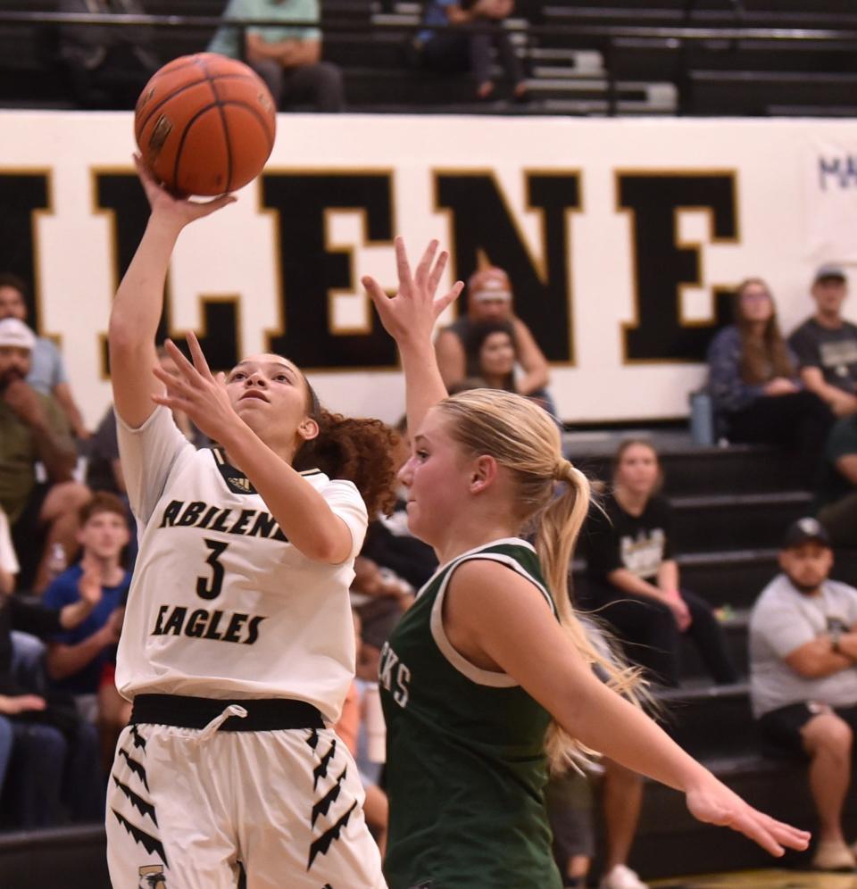Abilene High's Samia Cooper drives to the basket against a Breckenridge defender. The Lady Eagles beat Breckenridge 57-31 in the non-district game Tuesday at Eagle Gym.