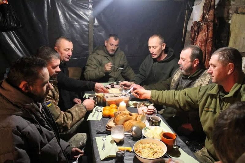 Ukrainian service members have their festive Christmas dinner at an unknown location in Ukraine