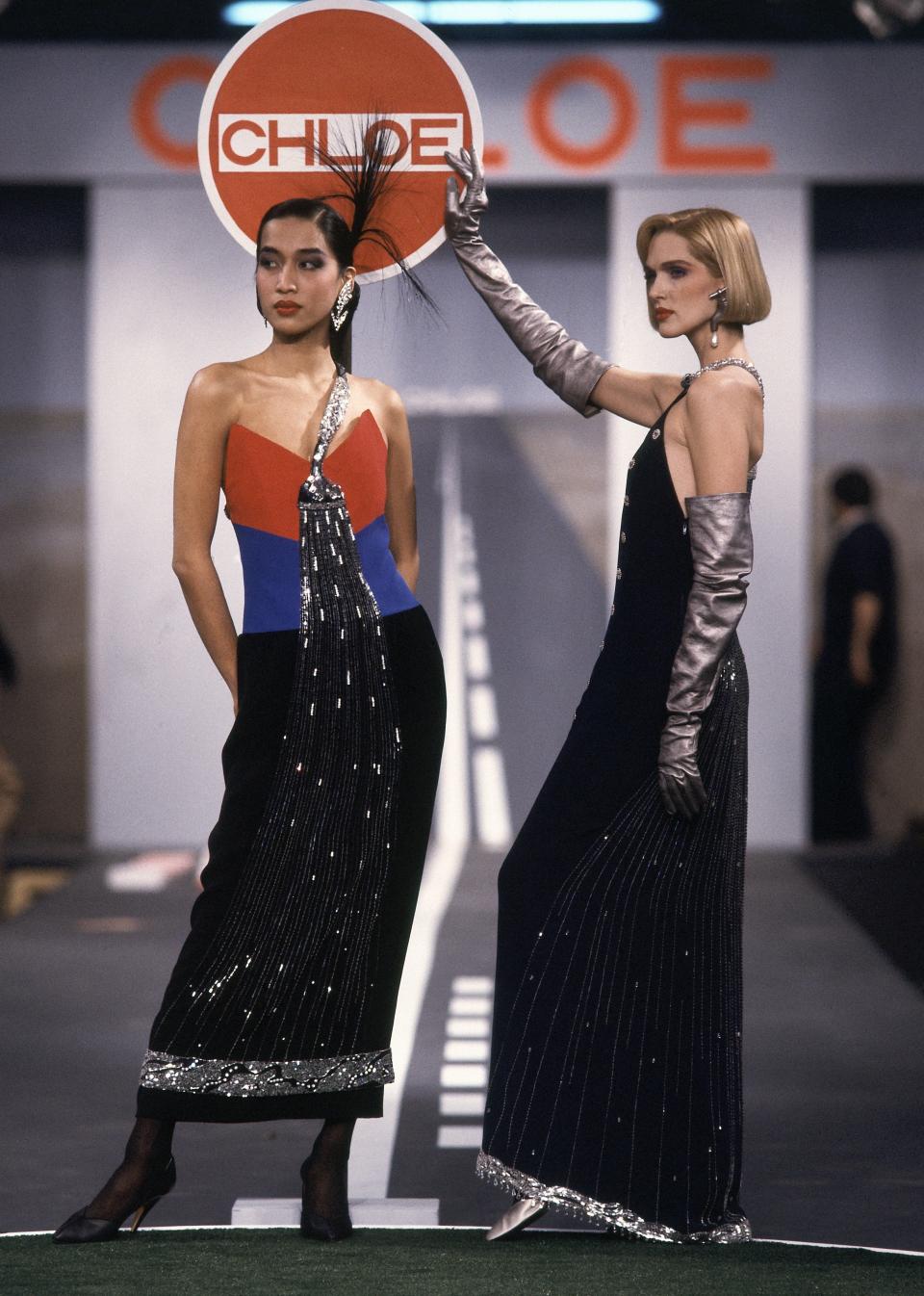 Models wearing splashy beaded faucet dreses in silk crepe on the runway of Karl Lagerfeld's Fall 1983 Ready-To-Wear collection for Chloe