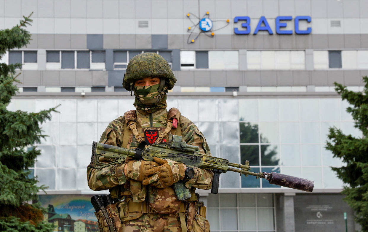 A service member stands guard near the Russian-controlled Zaporizhzhia Nuclear Power Plant following the arrival of the International Atomic Energy Agency (IAEA) expert mission in the course of Ukraine-Russia conflict outside Enerhodar in the Zaporizhzhia region, Ukraine, September 1, 2022. REUTERS/Alexander Ermochenko