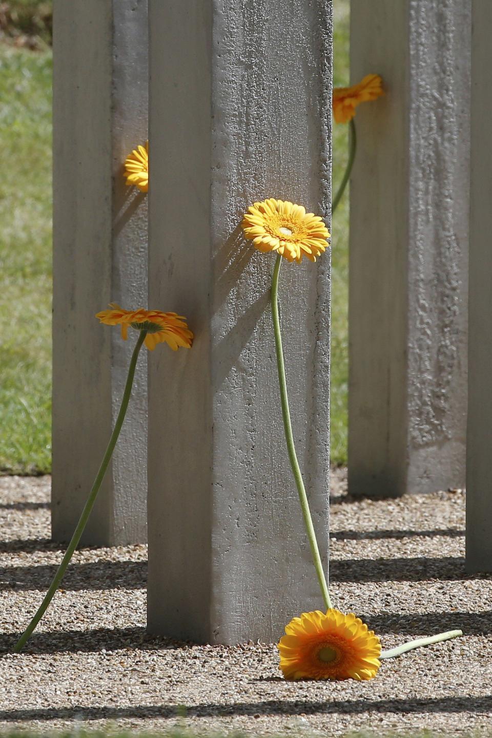 Flowers left by mourners are seen during a memorial event to victims of the July 7, 2005 London bombings, at the memorial in Hyde Park, central London, Britain July 7, 2015. Britain fell silent on Tuesday to commemorate the 10th anniversary of attacks targeting London public transport which killed 56 people, the first suicide bombings by Islamist militants in western Europe. (REUTERS/Peter Nicholls)