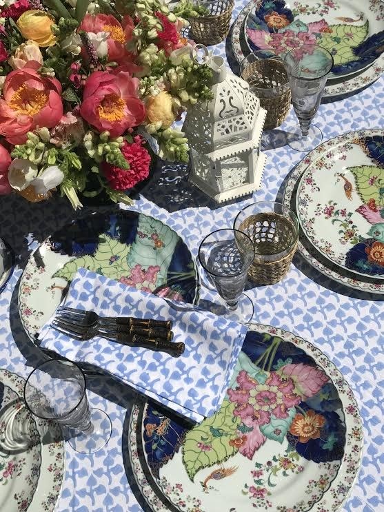 Mottahedeh's well-known Tobacco Leaf plates offset Amory's Big Sky tablecloth and napkins.