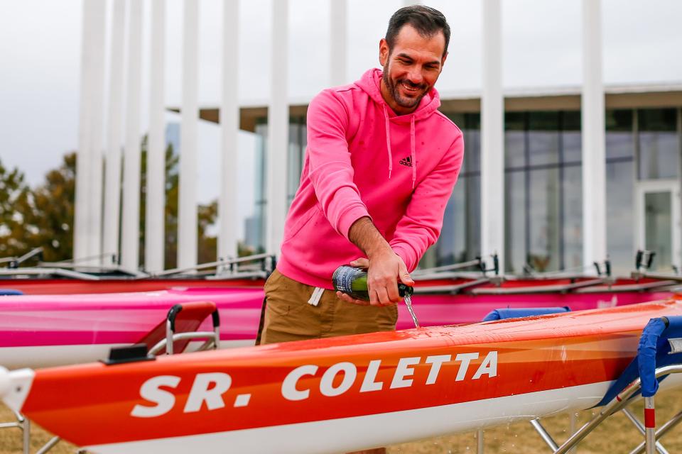 Danny Porter with ASTEC School sprays Champagne on boats Saturday during a ceremony honoring Sisters of Mercy at Chesapeake Boathouse in Oklahoma City.