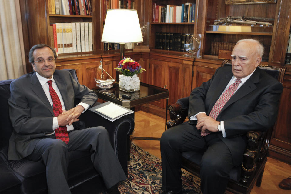 Greek President Karolos Papoulias, right, meets with Greek conservative leader Antonis Samaras before giving him a mandate to form a government in Athens, Monday, June 18, 2012. Samaras, who came first in Sunday's national election, says he will meet with leaders of all parties "that believe in Greece's European orientation and the euro" this afternoon in order to form a new coalition government. (AP Photo/Yorgos Karahalis, Pool)