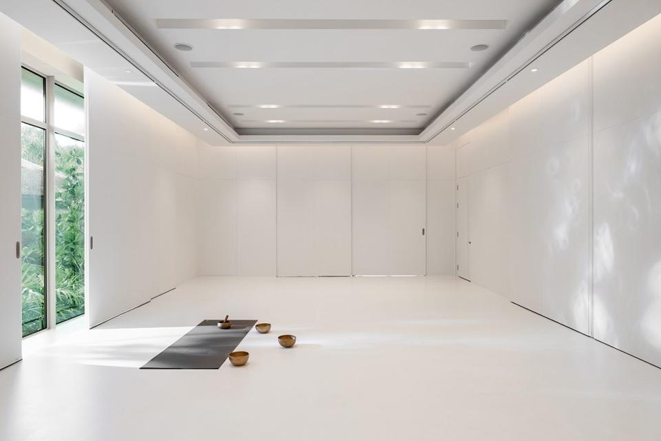 a room with white walls and a yoga mat on the floor