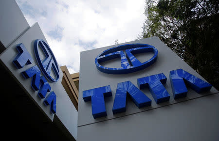 Tata Motors logos are seen at their flagship showroom before the announcement of their Q3 results in Mumbai February 14, 2013. REUTERS/Vivek Prakash/File Photo