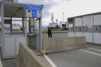 A man walks at the port of Shengjin, northwestern Albania, on Tuesday, Nov. 7, 2023. Italian Premier Giorgia Meloni announced that Albania had agreed to give temporary shelter to thousands of migrants who try to reach Italian shores while their asylum bids are being processed. Albania will offer two facilities, a quarantine area at the port of Shengjin and an accommodation center for those who will be deported at a former military airport in Gjader. (AP Photo/Armando Babani)