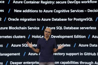 With a screen displaying some of the new Microsoft Azure services and updates in the background, Microsoft CEO Satya Nadella delivers the keynote address at Build, the company's annual conference for software developers Monday, May 6, 2019, in Seattle. (AP Photo/Elaine Thompson)