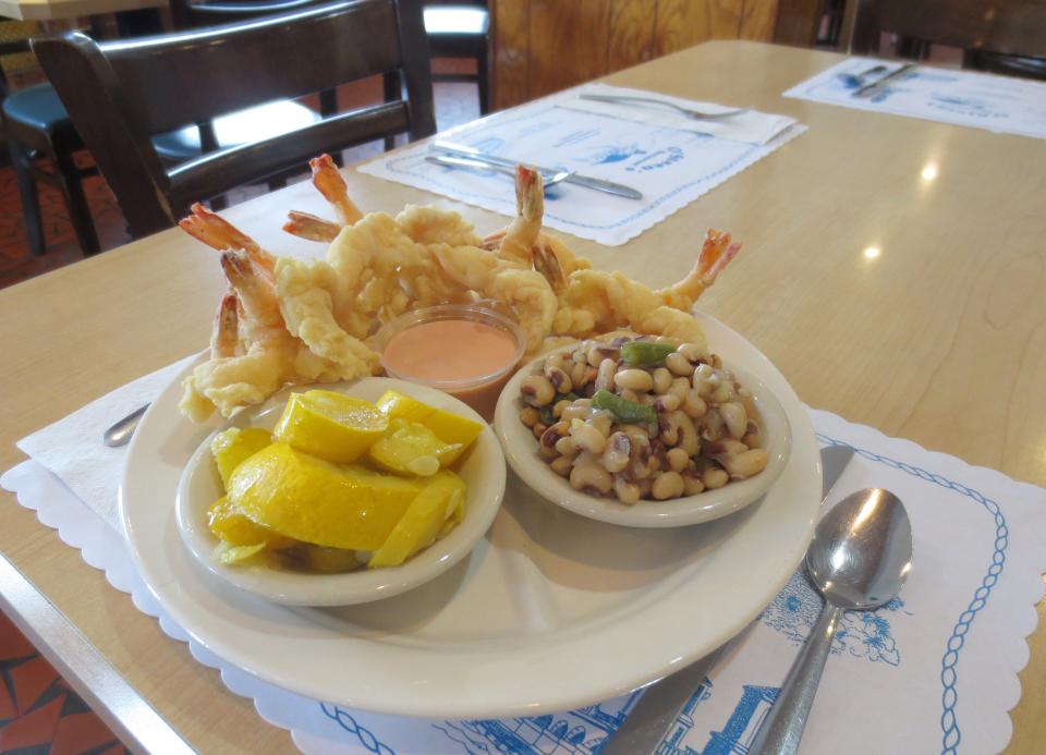 O'Steen's Restaurant on Anastasia Boulevard is best known for its fried shrimp, including butterflied shrimp served here with a side of squash and black-eyed peas.