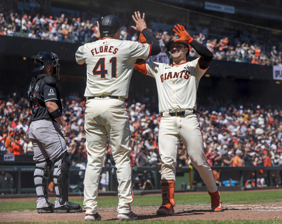 San Francisco Giants' Wilmer Flores (41) celebrates with teammate Patrick Bailey, right, after Bailey hit a home run during the fifth inning of a baseball game against the Arizona Diamondbacks, Saturday, April 20, 2024, in San Francisco. (AP Photo/Nic Coury)