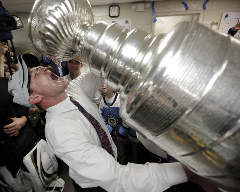 FILE - Pittsburgh Penguins coach Dan Bylsma drinks from the Stanley Cup after the Penguins defeated the Detroit Red Wings 2-1 to win Game 7 of the NHL hockey Stanley Cup Finals in Detroit, June 12, 2009. After making it to the Stanley Cup Final in 2008, the Penguins were barely over .500 in February of the next season, leading GM Ray Shero to fire Michel Therrien and promote Bylsma from the AHL. The results were almost immediate. (AP Photo/Paul Sancya, File)