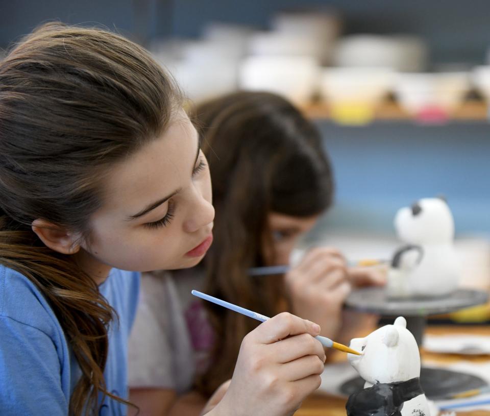 Rory Ziemke, 10, of East Canton puts her own touch on a ceramic figurine Saturday, April 13, 2024, at Glazed and Amused pottery painting in North Canton.