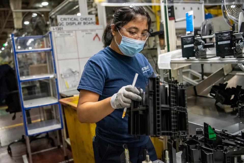 DENSO employee Suinawn Aye works in the manufacturing area on Wednesday, Nov. 10, 2021, at DENSO’s thermal manufacturing facility in Battle Creek.