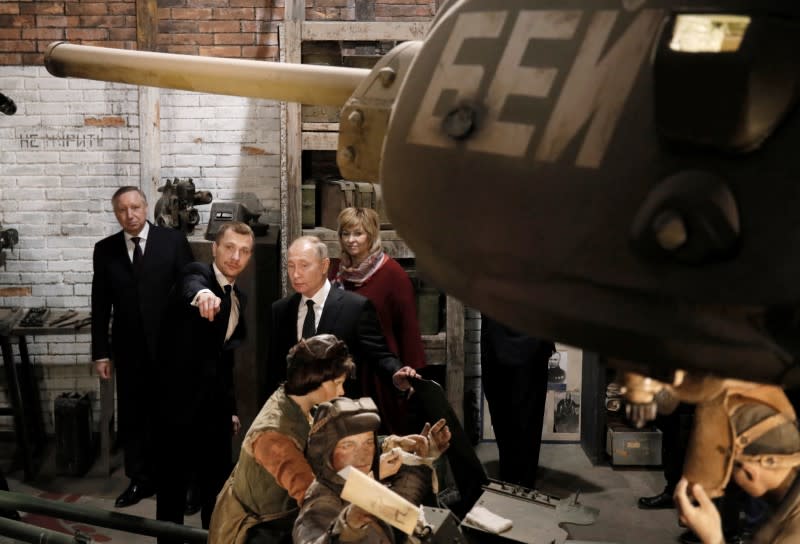 Russian President Vladimir Putin visits an exhibition depicting an armament repair shop at 3D panorama 'Memory speaks. The road through the war' in St.Petersburg