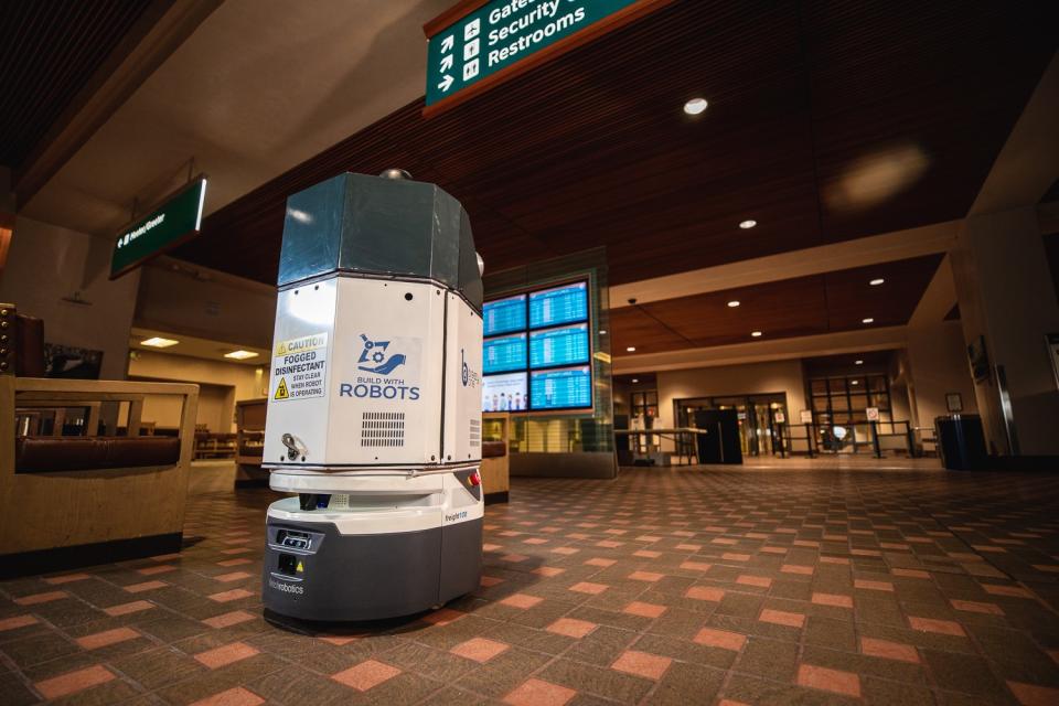 A mobile robot made by San Jose-based Fetch Robotics cleans the airport in Albuquerque.