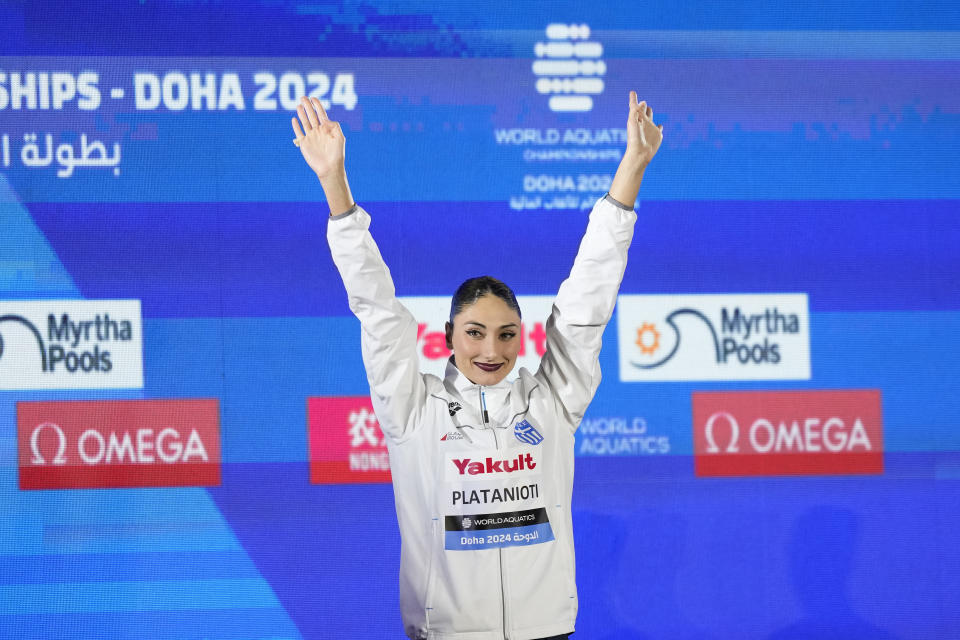 Gold medalist Evangelia Platanioti, of Greece, poses after the women's solo technical final of artistic swimming at the World Aquatics Championships in Doha, Qatar, Saturday, Feb. 3, 2024. (AP Photo/Lee Jin-man)