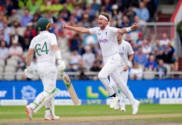 Stuart Broad, centre, celebrates the wicket of Dean Elgar, left