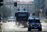 A vehicle of the Italian police sanitizes a street amid concerns about the spread of coronavirus disease (COVID-19) in Milan