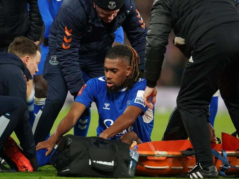 Everton’s Alex Iwobi lies injured on the pitch (AP)