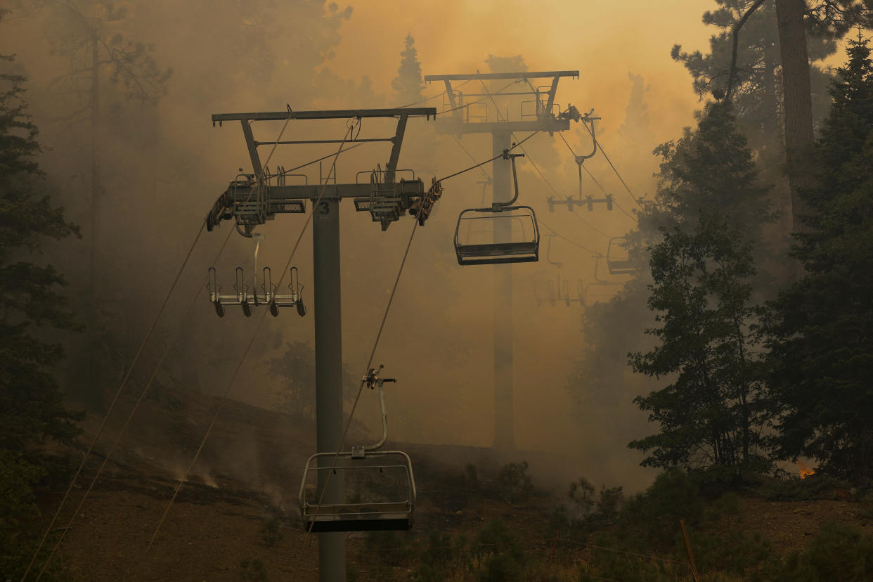 Smoke billows at the Mountain High Ski resort as the Bridge Fire continues to burn in Wrightwood, Calif., on Wednesday.