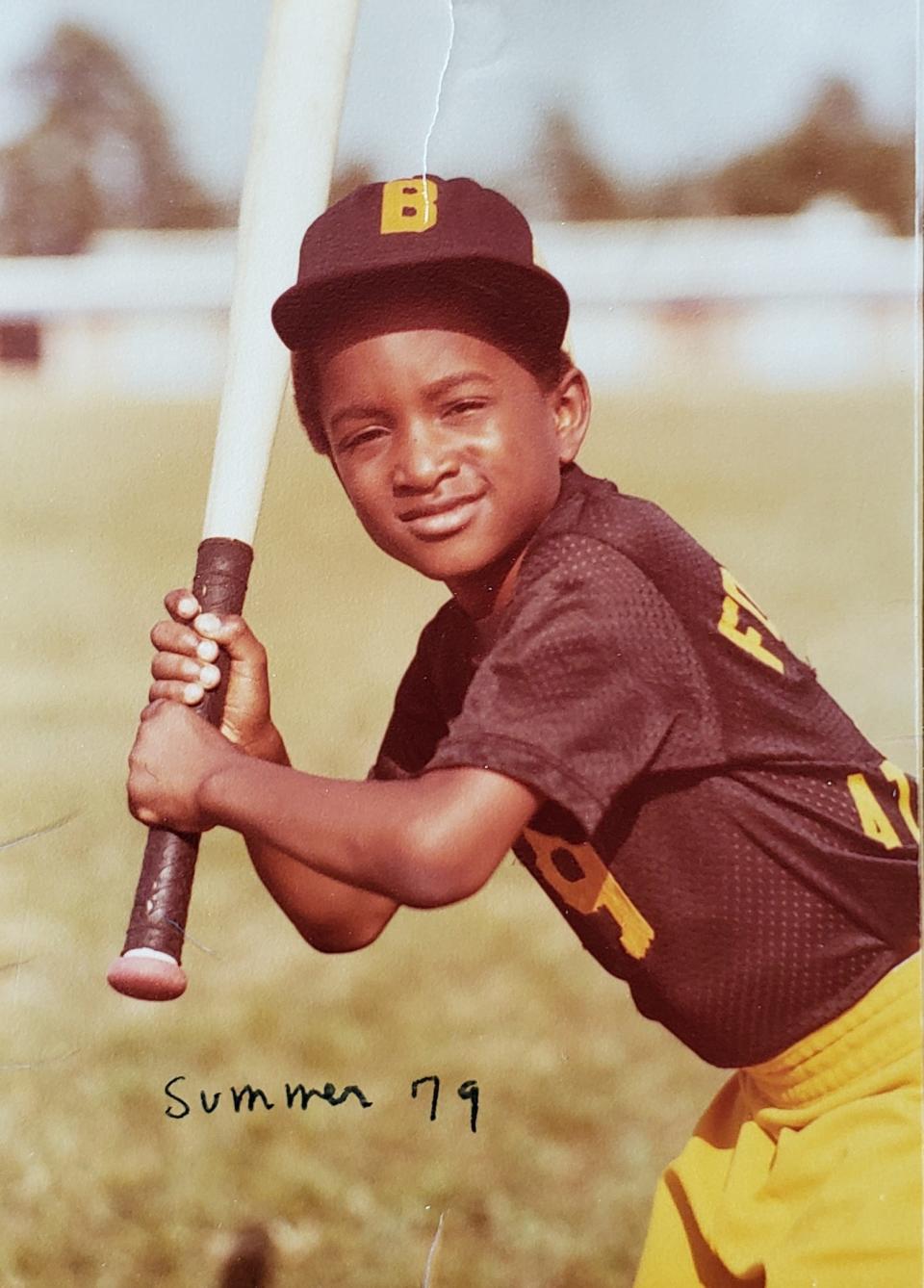 Myron Pitts poses for a photo with his youth baseball team from 1979, the Braves.