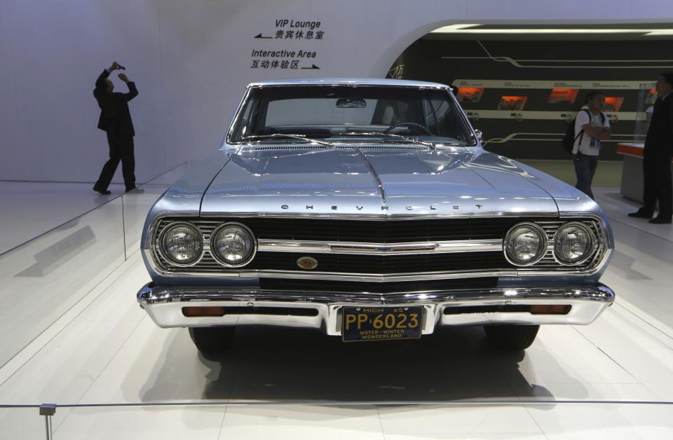 FILE - A 1965 Chevrolet Malibu is displayed at the company's booth during Guangzhou 2013 Auto Show in China's southern city of Guangzhou, Nov. 21, 2013. The Malibu, the last midsize car made by a Detroit automaker, is heading for the junkyard. General Motors confirmed Thursday, May 9, 2024, that it will stop making the car introduced in 1964 as the company focuses more on electric vehicles. (AP Photo/Kin Cheung, File)