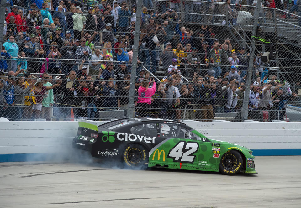 Kyle Larson does a burnout after winning the NASCAR Cup Series playoff auto race Sunday, Oct. 6, 2019, at Dover International Speedway in Dover, Del. (AP Photo/Jason Minto)