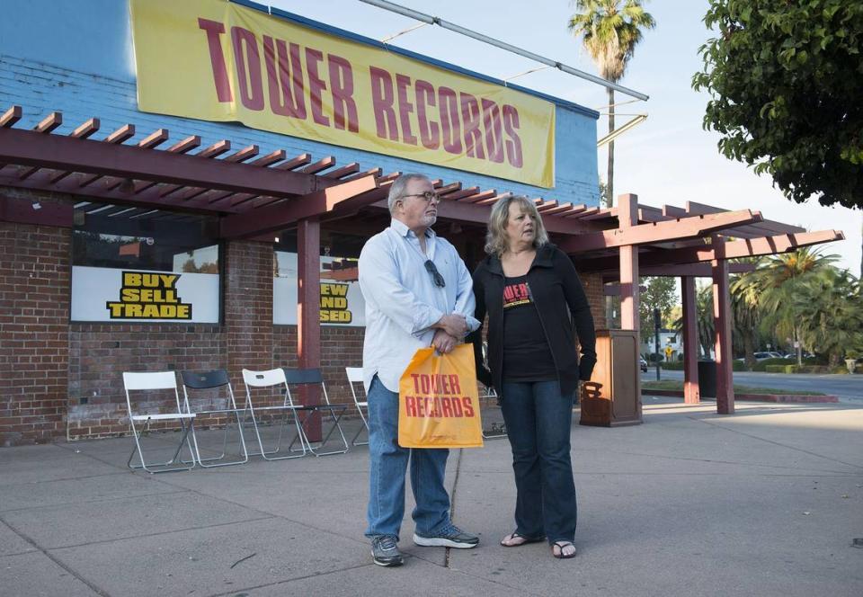 Long-time Tower employees Mike Farrce of Sacramento (1977-2002) and Terri Williams of Land Park (1975-2002) stand outside the old Tower Records on Broadway in 2015. Large banners with the Tower logo were hung to commemorate the Sacramento premiere of Colin Hanks’ documentary film “All Things Must Pass” about the history of company.