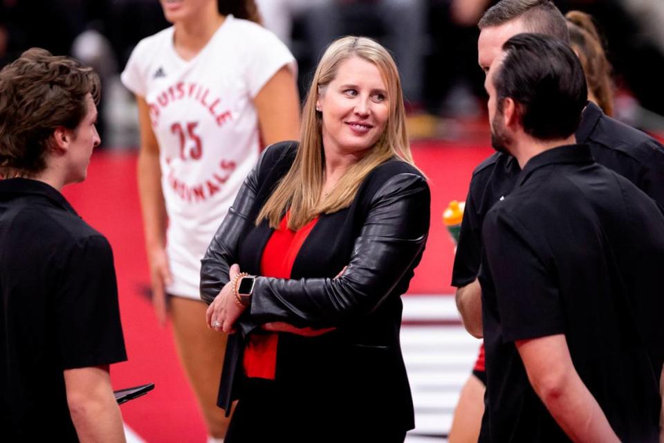 Dani Busboom Kelly (center) has coached Louisville volleyball to back-to-back wins over archrival Kentucky.