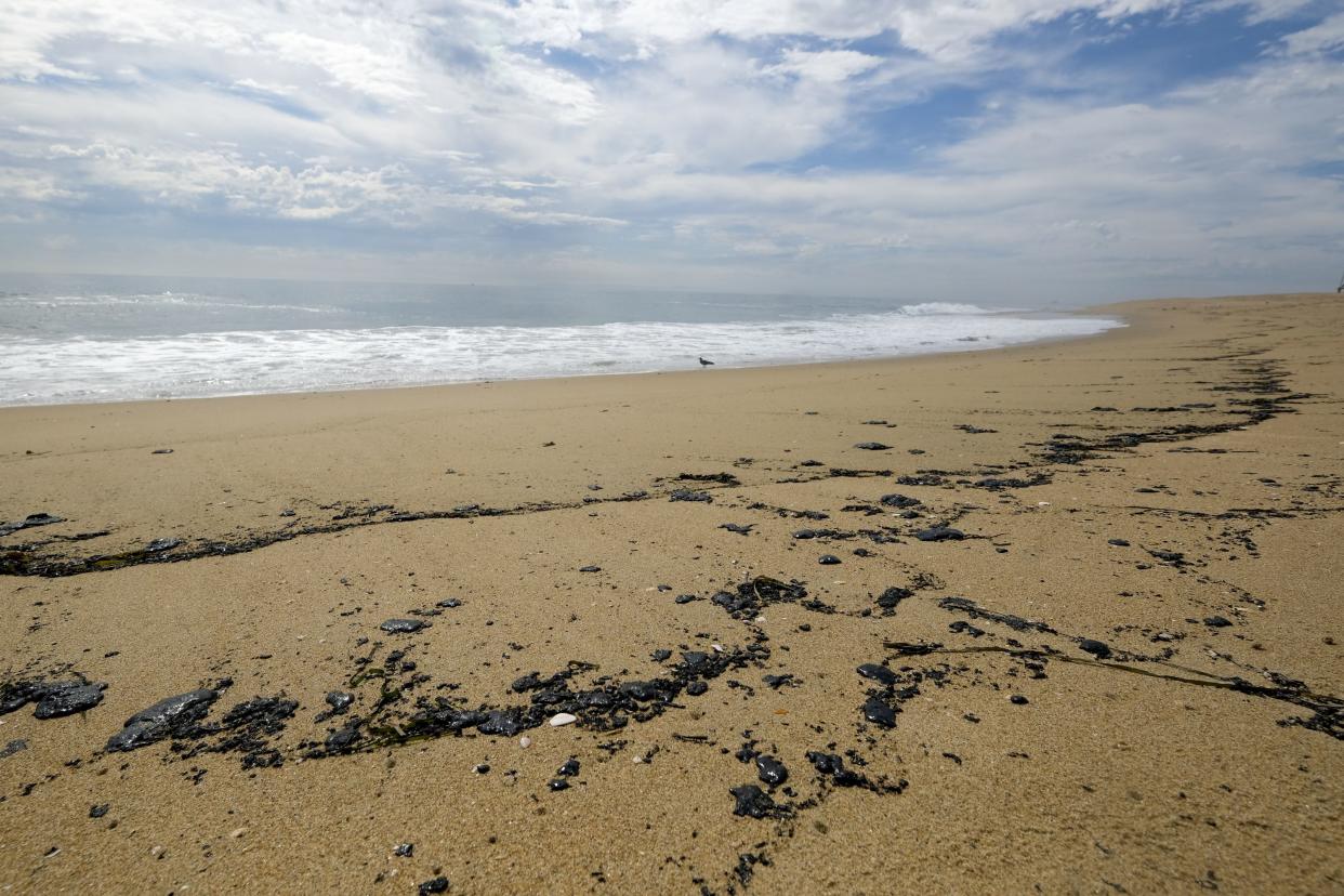 Oil washes up on a beach in Newport Beach, Calif. on Monday, Oct. 4, 2021. A major oil spill off the coast of Southern California fouled popular beaches and killed wildlife while crews scrambled Sunday to contain the crude before it spread further into protected wetlands.