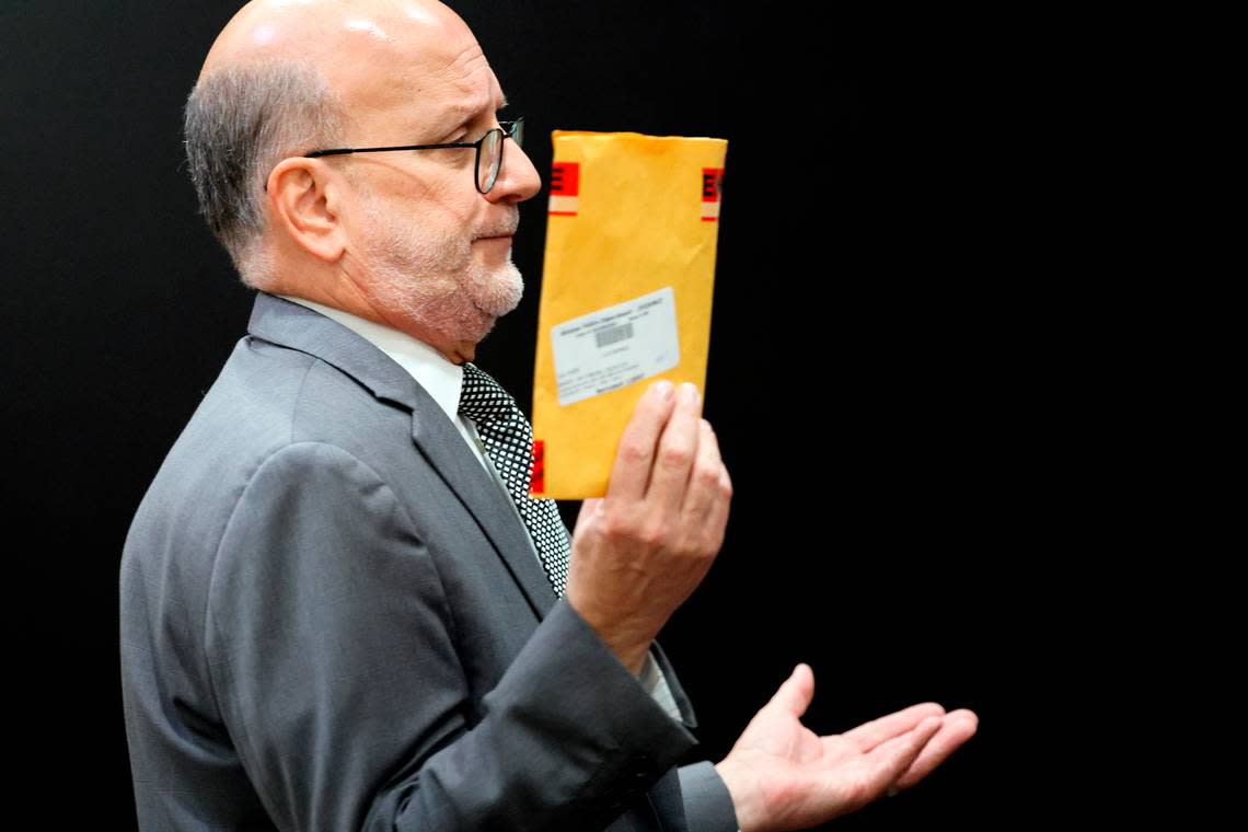 Defense attorney Stuart Adelstein holds up an evidence envelope containing a cell phone during his closing argument in the trial of Jamell Demons, better known as rapper YNW Melly, at the Broward County Courthouse in Fort Lauderdale on Wednesday, July 20, 2023. Demons, 22, is accused of killing two fellow rappers and conspiring to make it look like a drive-by shooting in October 2018. (Amy Beth Bennett / South Florida Sun Sentinel)