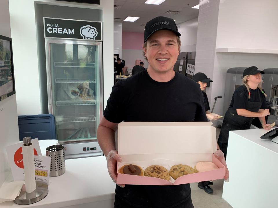 Cole Pendleton, franchise owner of Crumbl Cookies in Smyrna, stands at the front counter on opening day, Oct. 22, 2021.