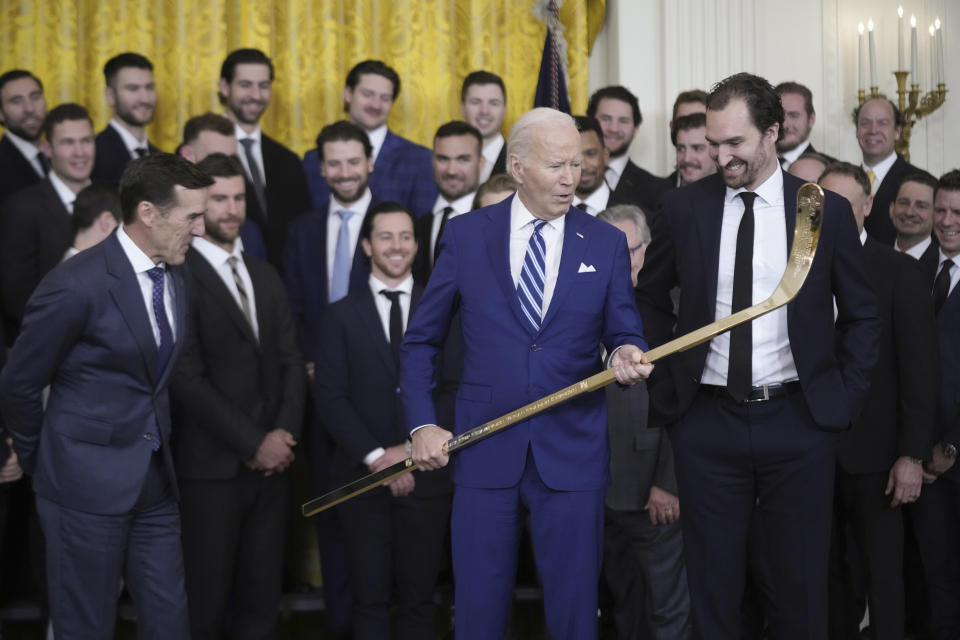 President Joe Biden looks over a hockey stick with team captain Mark Stone, during an event to celebrate the Vegas Golden Knights in their 2023 Stanley Cup victory in the East Room of the White House, Monday, Nov. 13, 2023, in Washington. (AP Photo/Andrew Harnik)