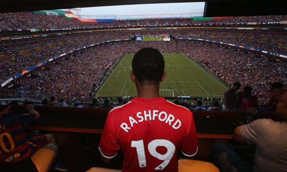 A Manchester United fan watches his team play Barcelona.