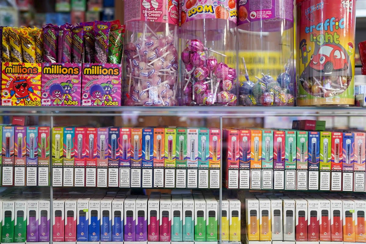 Vape flavours next to sweets in a shop (Jacob King/PA Wire)