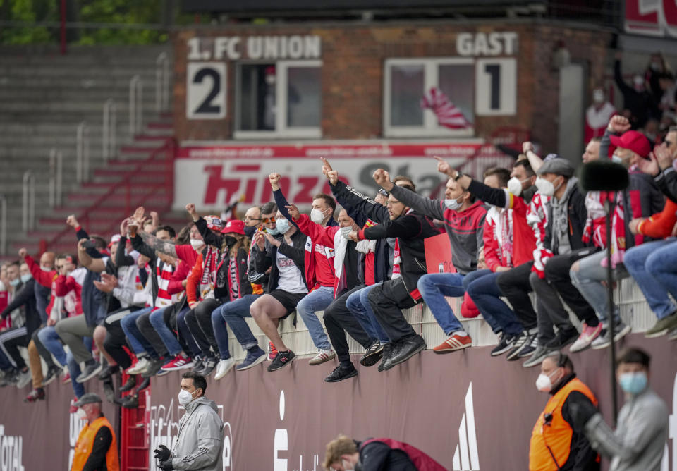 Union fans cheer for their team after the German Bundesliga soccer match between 1. FC Union Berlin and RB Leipzig in Berlin, Germany, Saturday, May 22, 2021. (AP Photo/Michael Sohn, pool)