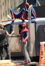 Andrew Garfield (C), his stunt double William Spencer (R) and a second stunt double are seen on set of "The Amazing Spider-Man 2" on June 22, 2013 in New York City.