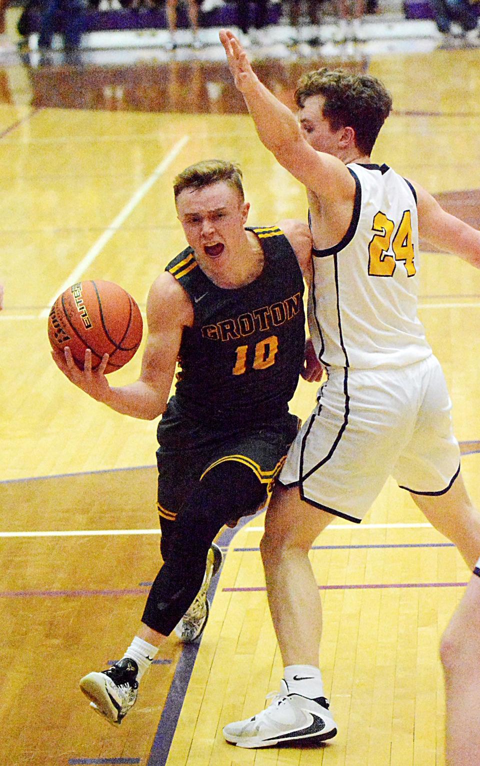 Groton Area's Lane Tietz drives against Sioux Valley's Oliver Vincent during their Class A SoDak 16 state-qualifying boys basketball game on Tuesday, March 7, 2023 in the Watertown Civic Arena.