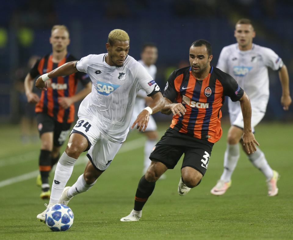 Hoffenheim forward Joelinton, left, and Shakhtar defender Ismaily Ismaily challenge for the ball during the Group F Champions League soccer match between Shakhtar Donetsk and Hoffenheim at the Metalist Stadium in Kharkiv, Ukraine, Wednesday, Sept. 19, 2018. (AP Photo/Efrem Lukatsky)