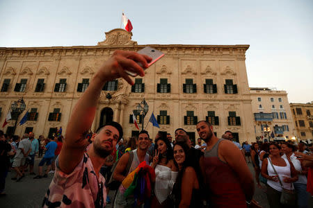 People take a group selfie during celebration after the Maltese parliament voted to legalise same-sex marriage on the Roman Catholic Mediterranean island, in Valletta, Malta, July 12, 2017. REUTERS/Darrin Zammit Lupi