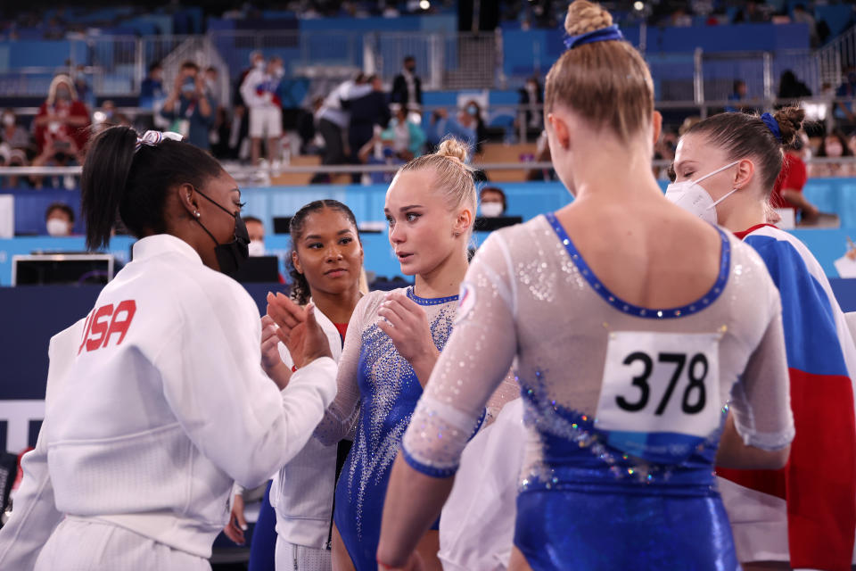 TOKYO, JAPAN - JULY 27: Simone Biles of Team United States congratulates Angelina Melnikova of Team ROC after Team ROC's gold medal win during the Women's Team Final on day four of the Tokyo 2020 Olympic Games at Ariake Gymnastics Centre on July 27, 2021 in Tokyo, Japan. (Photo by Laurence Griffiths/Getty Images)