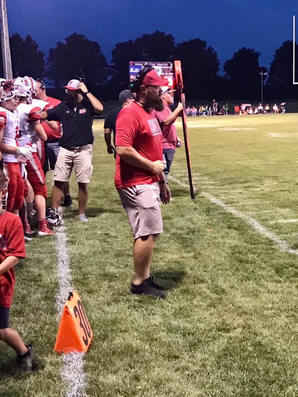 Elgin head football coach Zack Winslow walks the sidelines during a game at Cardington last season.