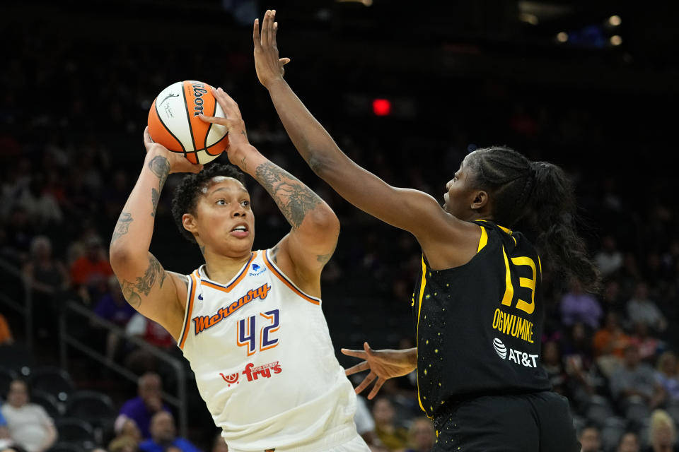 Phoenix Mercury center Brittney Griner (42) shoots Los Angeles Sparks forward Chiney Ogwumike (13) during the first half of a WNBA preseason basketball game, Friday, May 12, 2023, in Phoenix.  (AP Photo/Matt York)