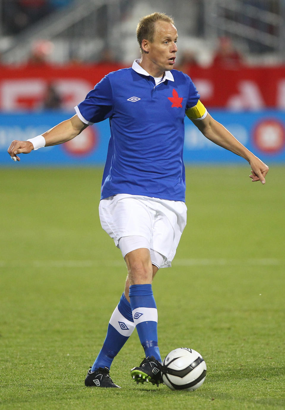 TORONTO, CANADA - JUNE 3: Kevin McKenna #4 of Canada with the ball against USA during their international friendly match on June 3, 2012 at BMO Field in Toronto, Ontario, Canada. (Photo by Tom Szczerbowski/Getty Images)