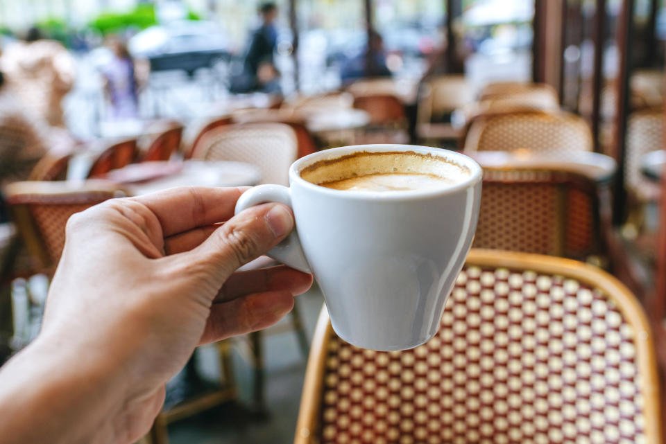 Close-up of man's hand with coffee cup in Paris bar