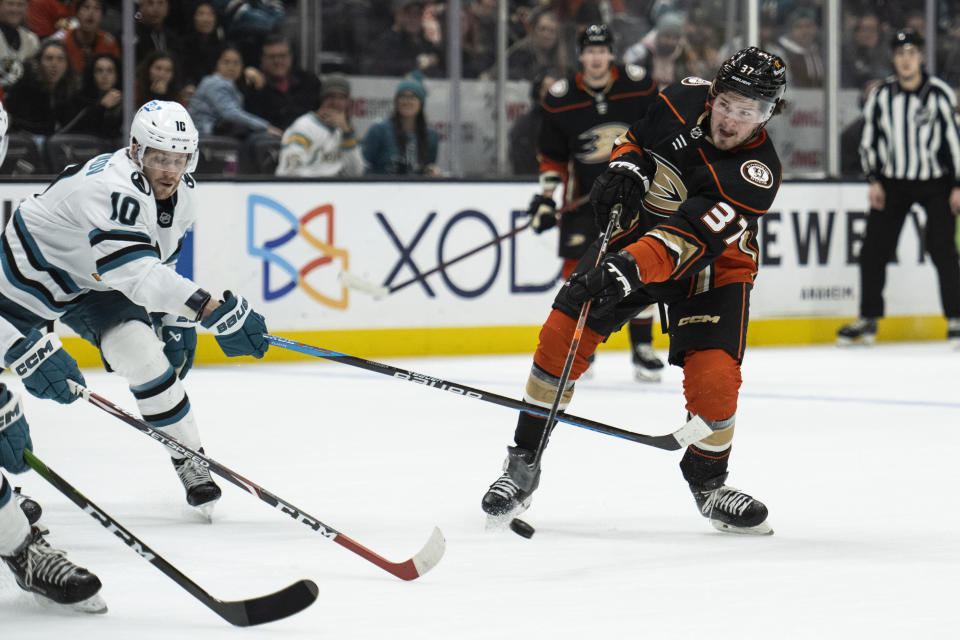 Anaheim Ducks center Mason McTavish (37) shoots past San Jose Sharks left wing Evgeny Svechnikov (10) for a goal during the third period of an NHL hockey game in Anaheim, Calif., Friday, Jan. 6, 2023. (AP Photo/Kyusung Gong)