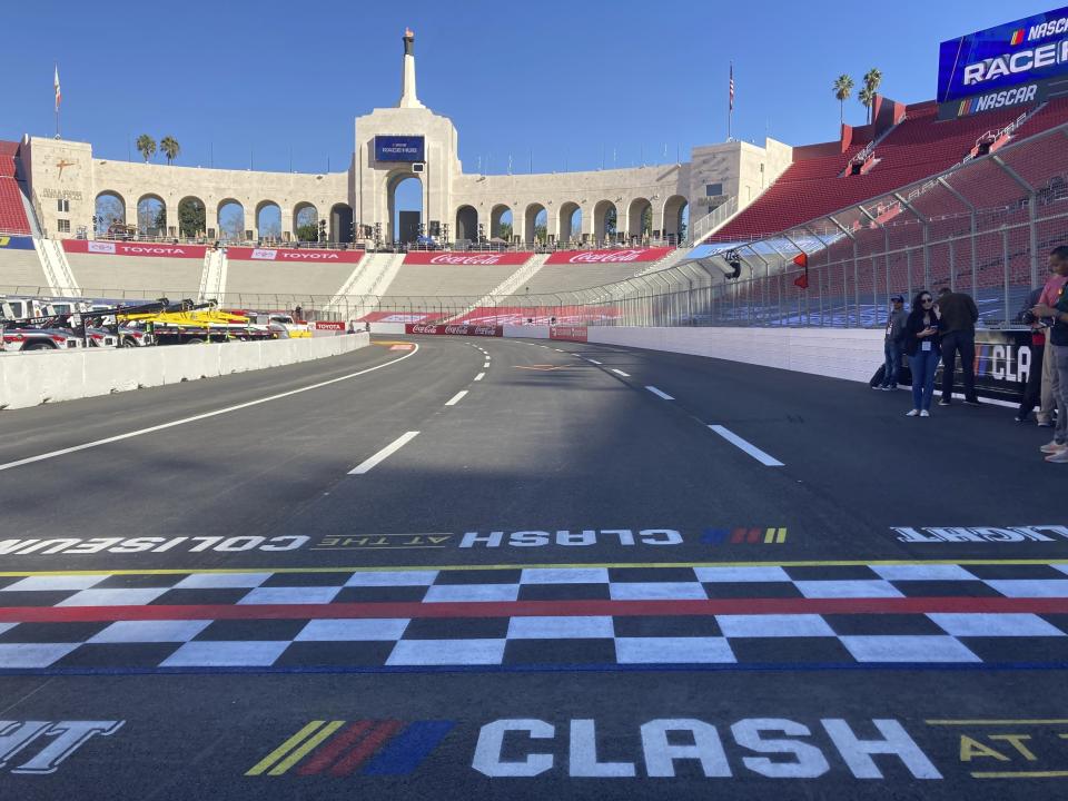 The start/finish line of a temporary auto racing track is viewed inside LA Coliseum ahead of a NASCAR exhibition race in Los Angeles, Friday, Feb. 4, 2022. NASCAR is hitting Los Angeles a week ahead of the Super Bowl, grabbing the spotlight with its wildest idea yet: The Clash, the unofficial season-opening, stock-car version of the Pro Bowl, will run at the iconic coliseum in a made-for-Fox Sports spectacular. (AP Photo/Jenna Fryer)